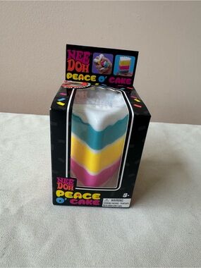NeeDoh Nee Doh Peace O Cake Layered Squeezy Toy - Pink, Yellow, Blue, White